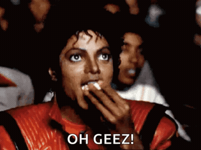 Man In Red Jacket Eating Popcorn Saying Oh Geez GIF