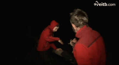 Man In Red Jacket Held By Person Eitb.com GIF