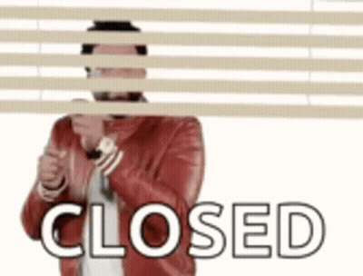 Man In Red Jacket Hiding Behind Blinds Closed GIF