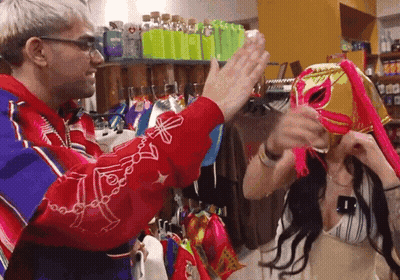 Man In Red Jacket High-Fiving Woman In Mask GIF