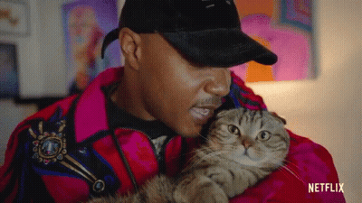 Man In Red Jacket Holding Cat GIF