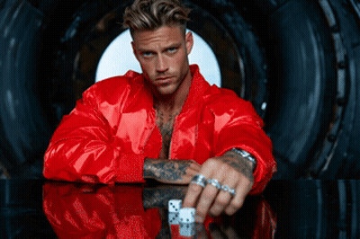 Man In Red Jacket Holding Dice GIF
