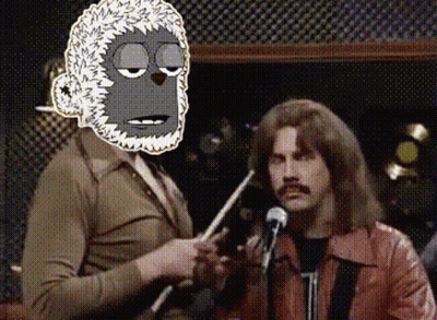 Man In Red Jacket Holding Microphone With Cartoon Monkey Behind GIF