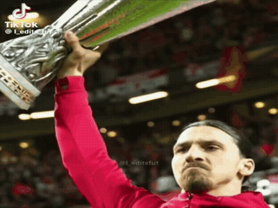 Man In Red Jacket Holding Trophy GIF