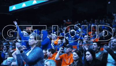 Man In Red Jacket In Front Of Crowd GIF
