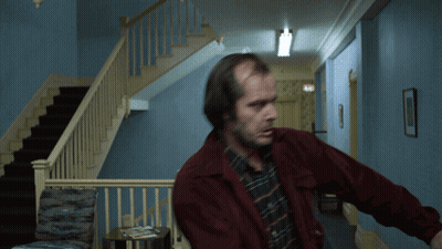 Man In Red Jacket In Hallway Near Stairs GIF