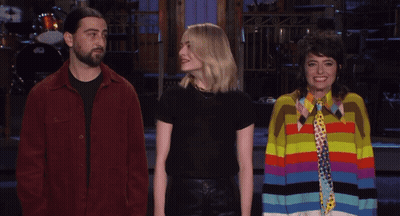 Man In Red Jacket Next To Two Women GIF