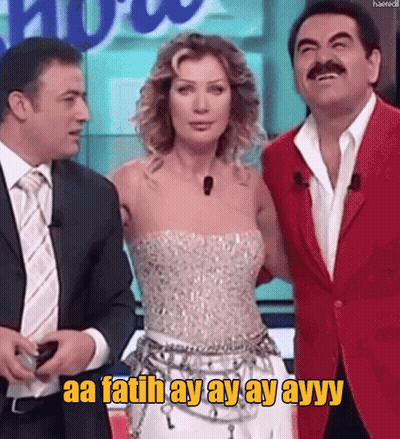 Man In Red Jacket Next To Woman In White Dress Saying Aa Fatih Ay Ay Ayy GIF