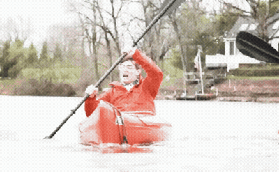Man In Red Jacket Paddling Red Kayak In Lake GIF