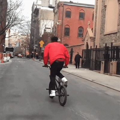 Man In Red Jacket Riding Bike GIF