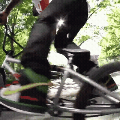 Man In Red Jacket Riding Bike Next To Fire Hydrant GIF