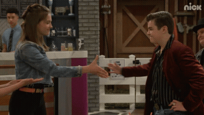 Man In Red Jacket Shaking Hands With Girl In Denim GIF