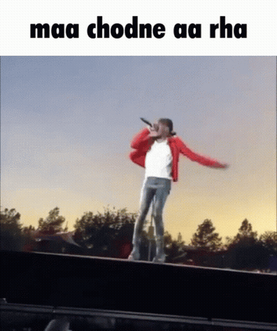 Man In Red Jacket Singing Into Microphone On Railing GIF