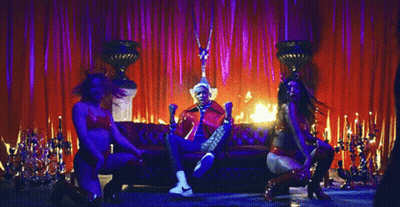 Man In Red Jacket Sitting By Fire GIF