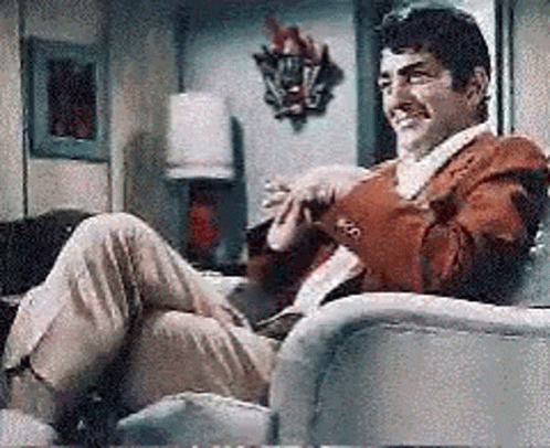 Man In Red Jacket Sitting Crossed Legs GIF