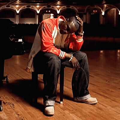 Man In Red Jacket Sitting GIF