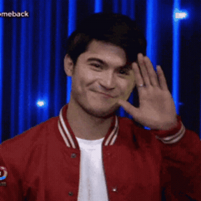 Man In Red Jacket Smiling And Waving GIF