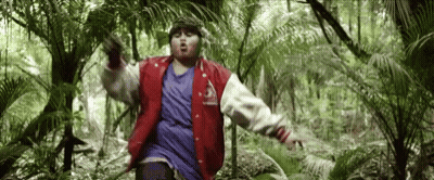 Man In Red Jacket Standing In Jungle GIF