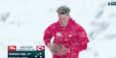 Man In Red Jacket Standing In Snow With Kansas City NFL Weather Sign GIF