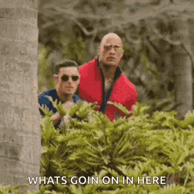 Man In Red Jacket Standing Next To Man In Blue Shirt GIF