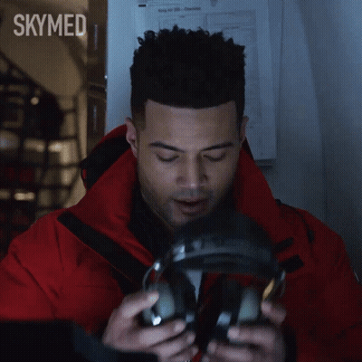 Man In Red Jacket Talking Into Microphone With Skymed GIF