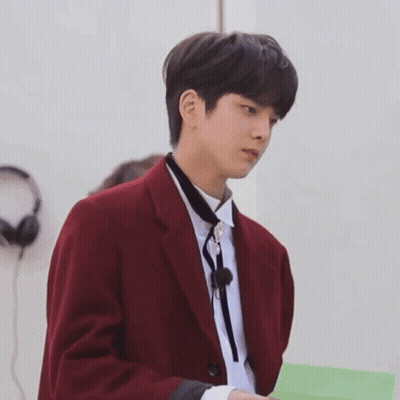 Man In Red Jacket Tie Holding Green Paper GIF