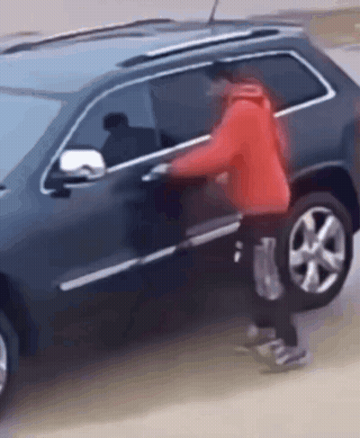 Man In Red Jacket Trying To Get Into Black SUV GIF