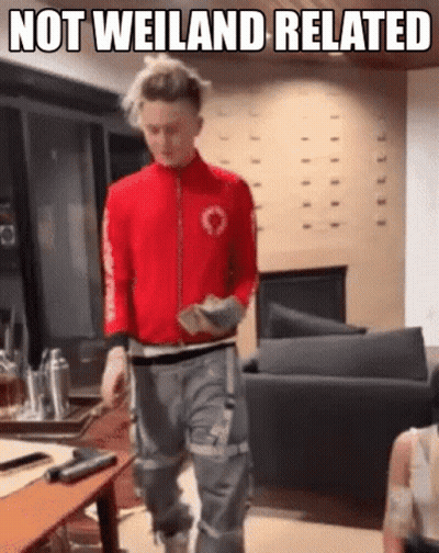 Man In Red Jacket Walking Living Room Not Weiland Related GIF