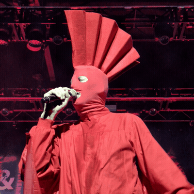 Man In Red Jacket With Arrows Smiling GIF
