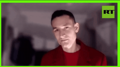 Man In Red Jacket With Green Frame GIF
