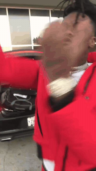 Man In Red Jacket With Hands Up By Car GIF