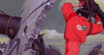 Man In Red Jacket With Heart On Back Standing In Front Of Broken Wall GIF