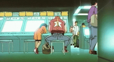 Man In Red Jacket With Star At Arcade Machine GIF