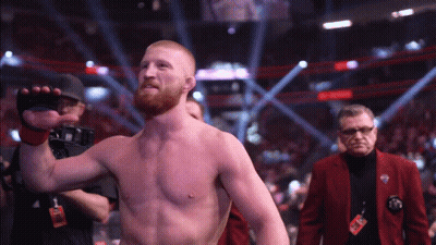 Man In Red Jacket With UFC Lanyard GIF