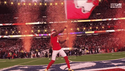 Man In Red Jersey Dancing On Football Field In Front Of CBS Sports Sign GIF