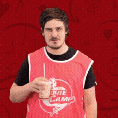 Man In Red Jersey Drinking From Cup Saying Nuda GIF