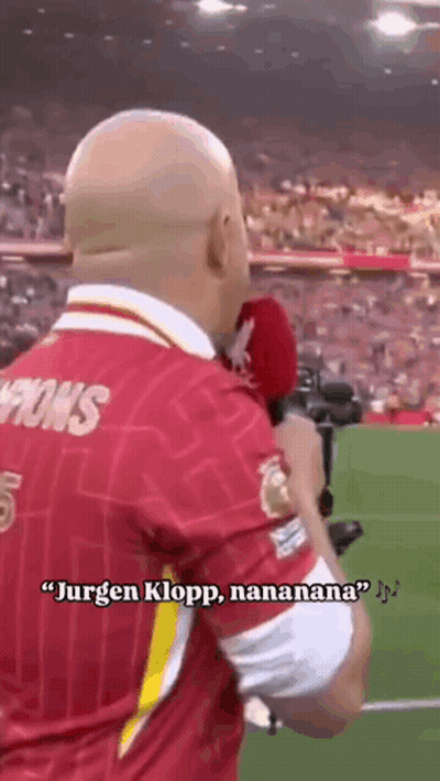 Man In Red Jersey Holding Microphone Talking To Crowd GIF