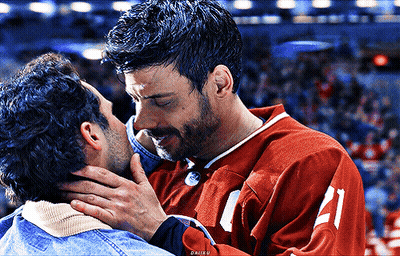 Man In Red Jersey Kissing Another Man GIF
