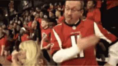 Man In Red Jersey Number 21 Dancing In Crowd GIF