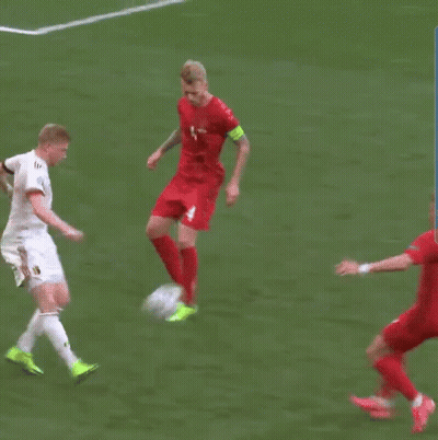 Man In Red Jersey Number 4 Kicks Soccer Ball GIF