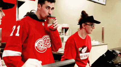 Man In Red Jersey Number 71 Drinking Coffee GIF
