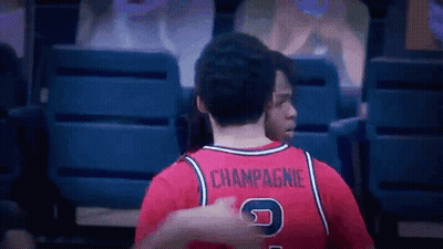 Man in Red Jersey With Champagne on Back
