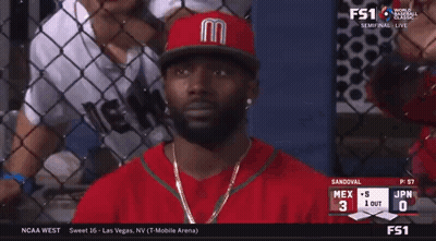 Man in Red Jersey With Letter M Watching Baseball