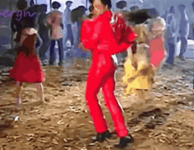 Man In Red Jumpsuit Dancing In Front Of Crowd GIF