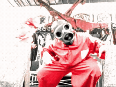 Man In Red Jumpsuit Holding Two Guns GIF