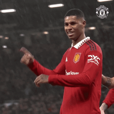 Man In Red Manchester United Jersey Holding Finger To Head GIF
