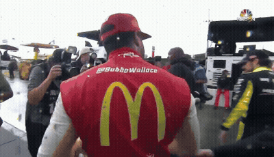 Man In Red McDonald's Vest In Front Of Crowd GIF