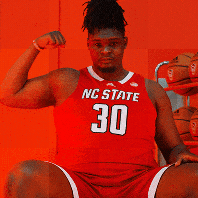 Man In Red NC State Jersey Flexing Arm GIF
