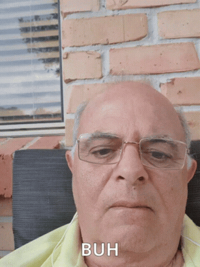 Man In Red Plaid Shirt Smiling In Front Of TamilChatroom.in Logo GIF