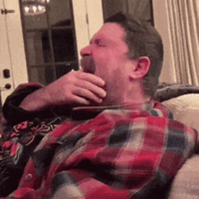 Man In Red Polo Shirt On Couch Saying She's Lying GIF